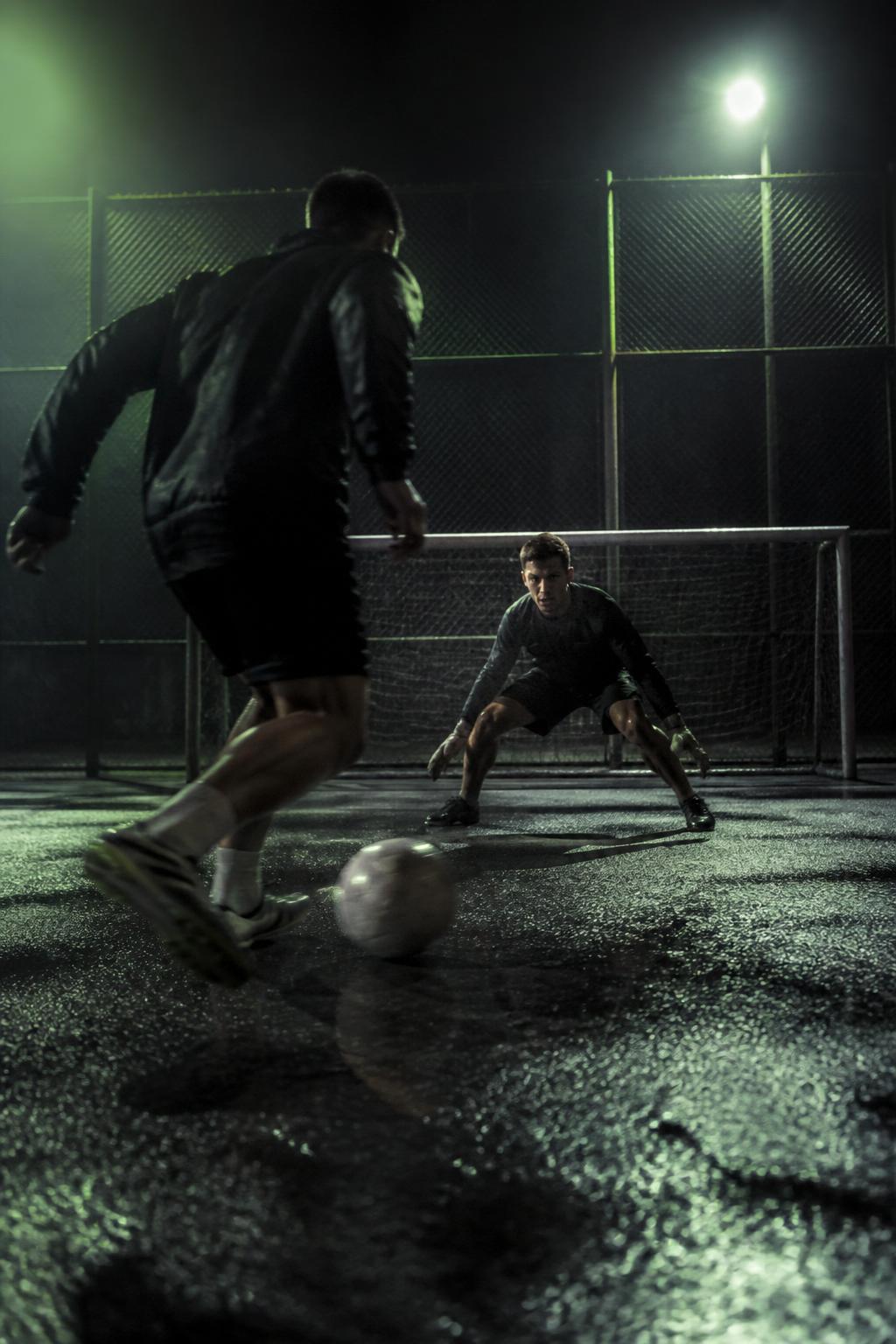 1v1 street football duel under floodlights
